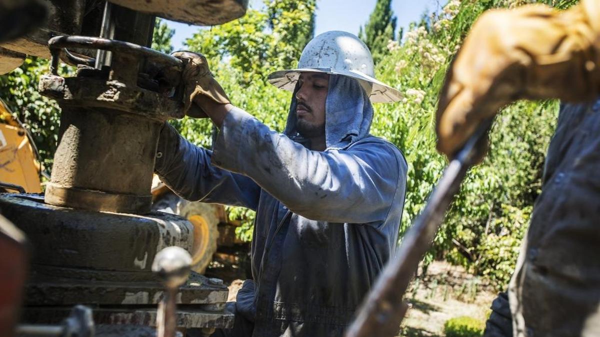 
Calwater Drilling Co. employee Albert Munoz drills a new residential well at a home on Belmira Road in Atwater on June 25, 2015. 
