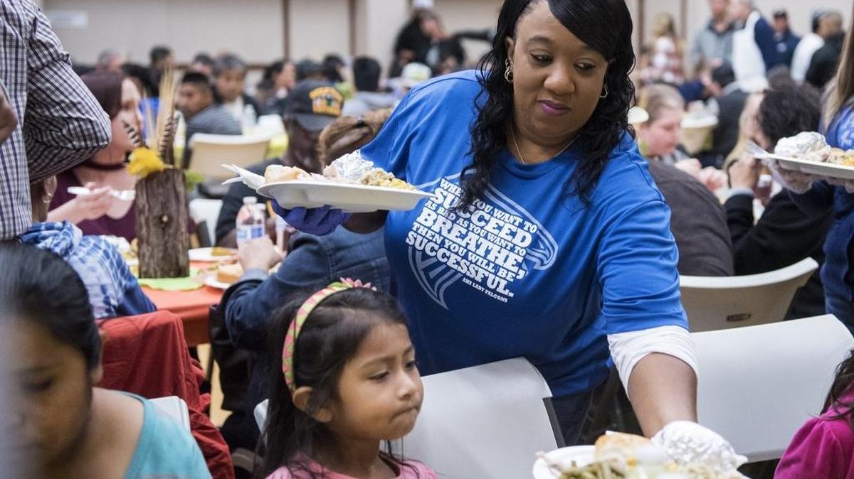 Volunteer Latanya Love, 47, of Atwater, serves food during a Thanksgiving meal organized by the Merced County Rescue Mission, at the American Legion Hall located at 933 W. Main Street in Merced, Calif., on Thursday, Nov. 23, 2017. According to Bruce Metcalf, Director of the Merced County Rescue Mission, volunteers prepared to serve up to 1,000 people.