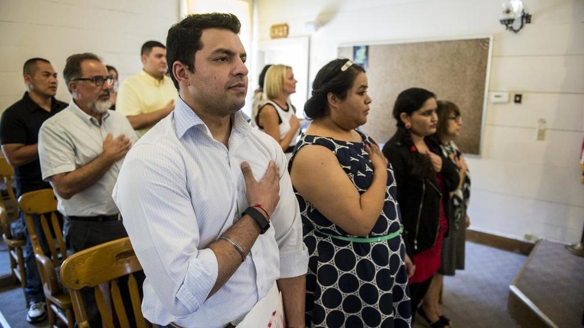 Livingston resident and India native Jeewan Pallah, 27, places his hand over his heart during the national anthem before taking the oath of allegiance to become a United States citizen during a special naturalization ceremony at the Mariposa County Courthouse on Wednesday, July 27, 2016, in Mariposa.
