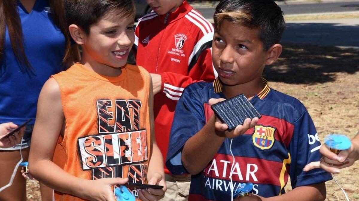 Giovanny Ramirez, 10, right, follows instruction with his mini solar panel and fan as Aaron Figueroa, 9, watches on Monday afternoon during a lesson on renewable energy in Merced.