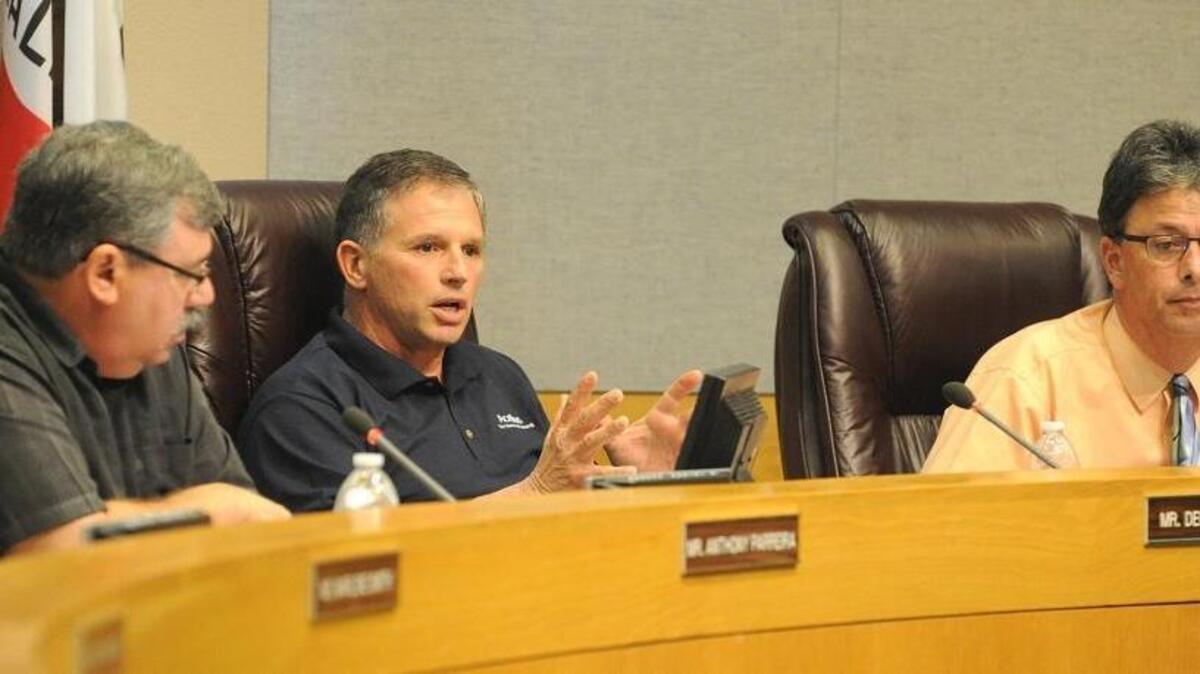 The Los Banos Unified School Board voted 5-0 Wednesday to terminate a hotly disputed construction contract, two days after it was revealed that the contract was the at the center of criminal probe that resulted this week in the arrests of the one school board member the owner of the construction company. Trustees President Anthony Parreira, left and member Dominic Falasco, right, listen to member Dennis Areias speak during a Town Hall meeting Feb. 5, 2015 in Los Banos. Enterprise file photograph