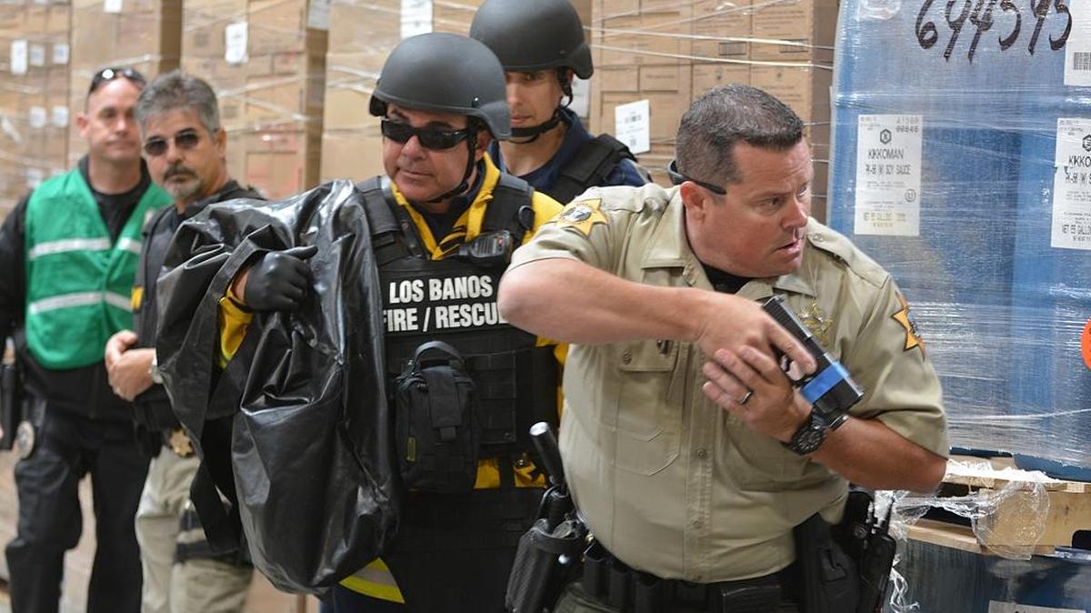 A task force made up of police, fire and emergency medical personnel make their way through a warehouse to look for victims during an active shooter training exercise Thursday morning at the Kagome food plant in Los Banos.