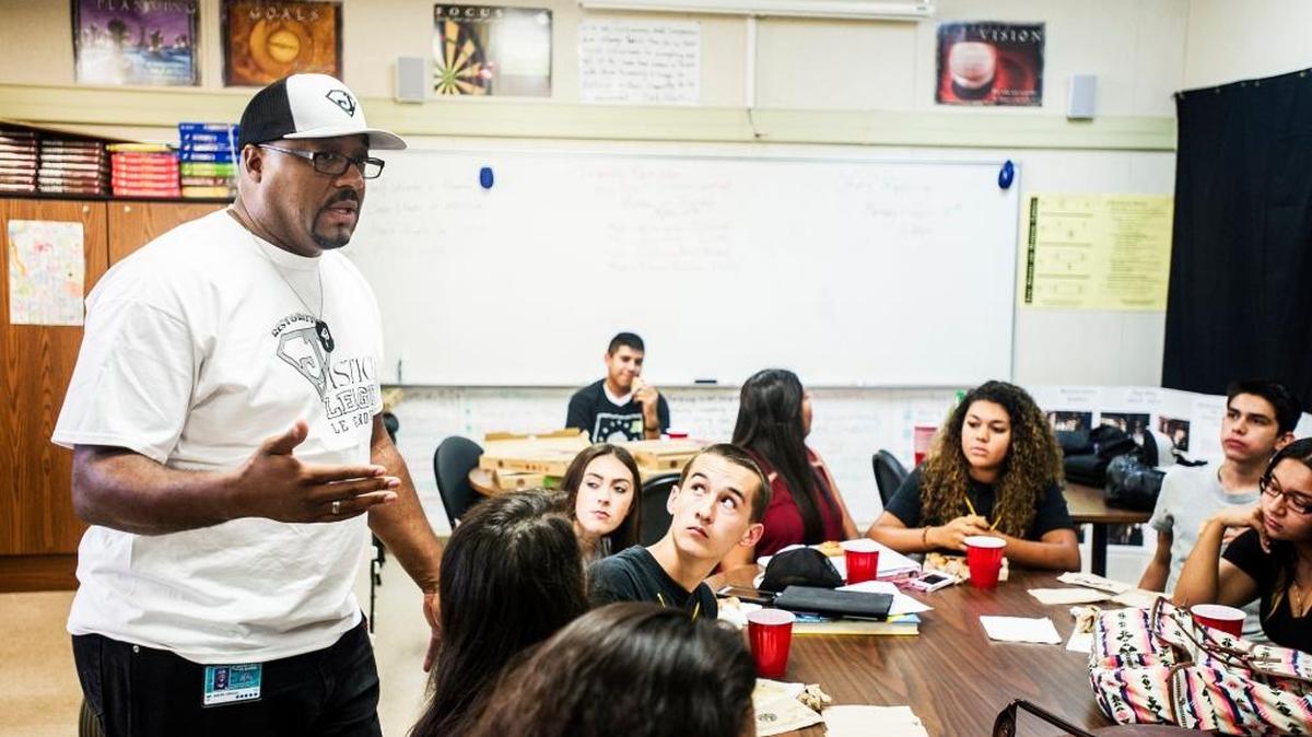 Andre Griggs, left, coordinator of the Le Grand Restorative Justice League, speaks to students during a meeting at Le Grand High School in August. The program trains students to offer support to peers who may be facing challenges at school, home or in the streets.