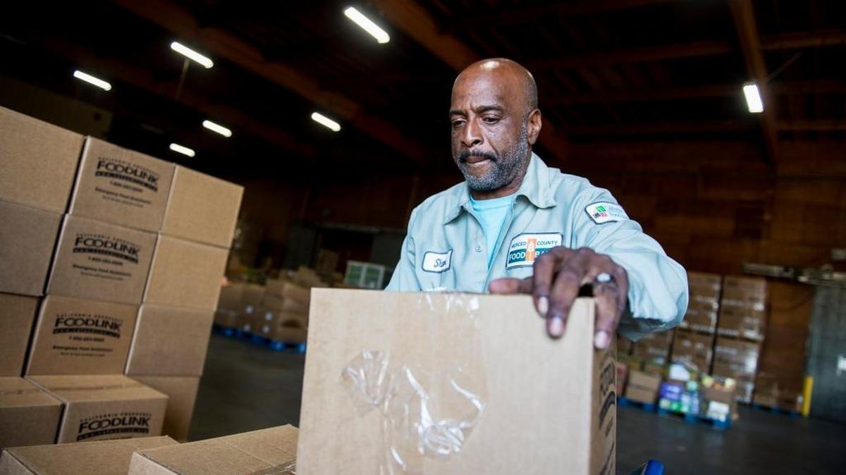 Shawn Moore, 49, of Atwater stacks boxes of food at the Merced County Food Bank in Merced, Calif., on Tuesday, Oct. 4, 2016. The boxes each contain roughly 30 pounds of nonperishable food designed to feed four people for three to four days, according to Merced Food Bank Executive Director Bill Gibbs.