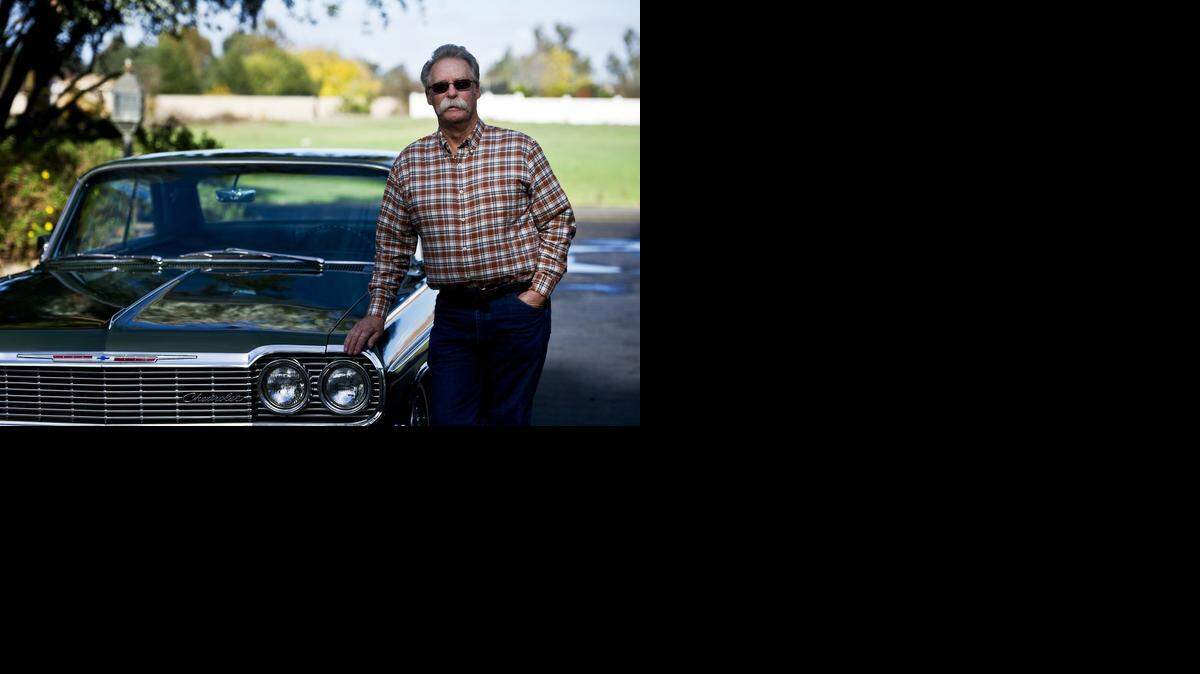 
Bob Anderson, 69, of Merced shows off his 1964 Chevrolet Impala Super Sport hardtop at his home last week.  Anderson has owned the car, which has undergone hree restorations, since 1975.
