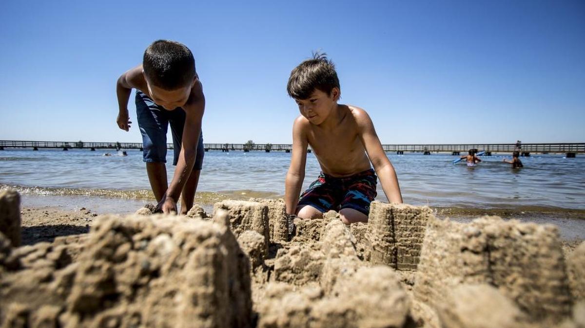 Cash Martinez, 6, of San Jose, left, and Mateo Heredia, 9, of Patterson put the finishing touches on a sand castle at Lake Yosemite on Saturday in Merced.