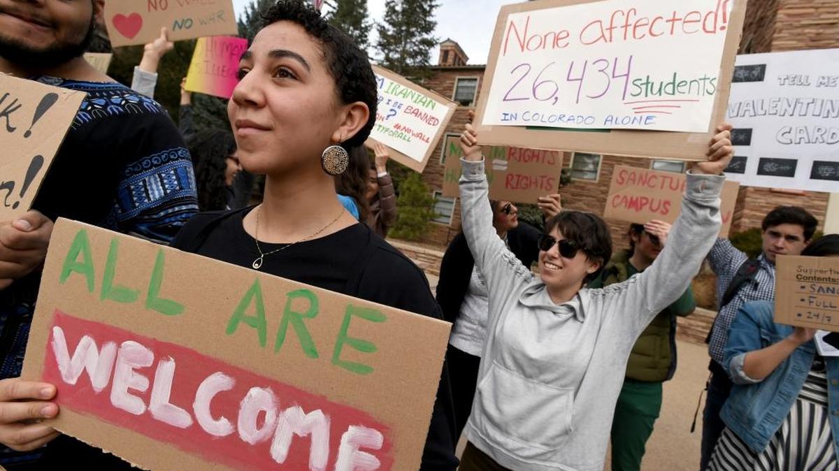 Gwendalynn Roebeke, left, and dozens of others protest at the University of Colorado in Boulder on Thursday against an executive order restricting travelers to the United States.