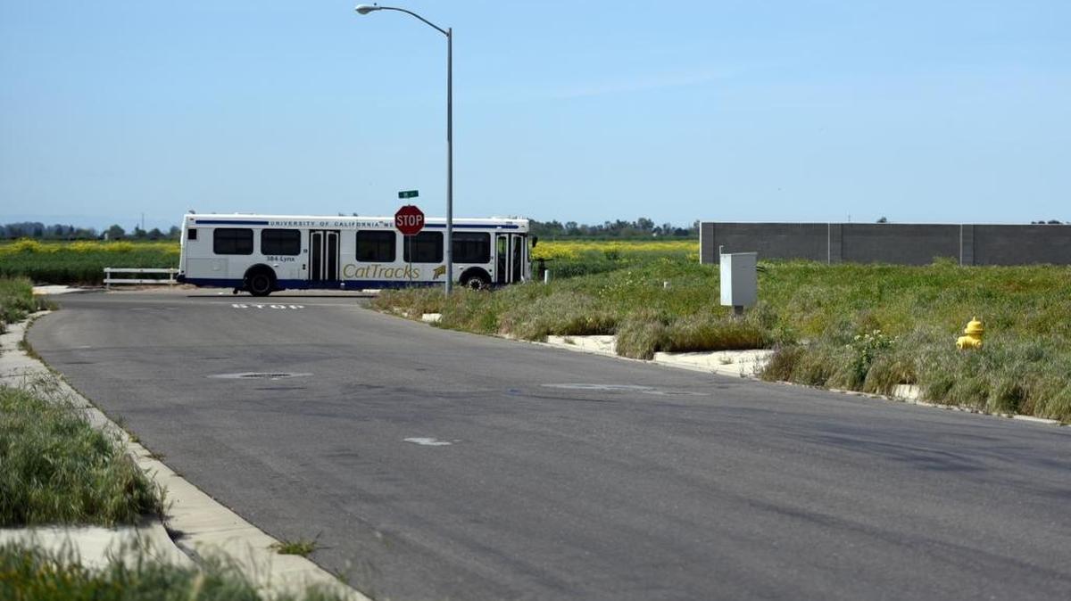 A bus passes between undeveloped lots and the site of a new subdivision on M Street on Thursday. Merced’s Planning Commission on Wednesday approved the city’s first new large subdivision since 2008, according to city staff.