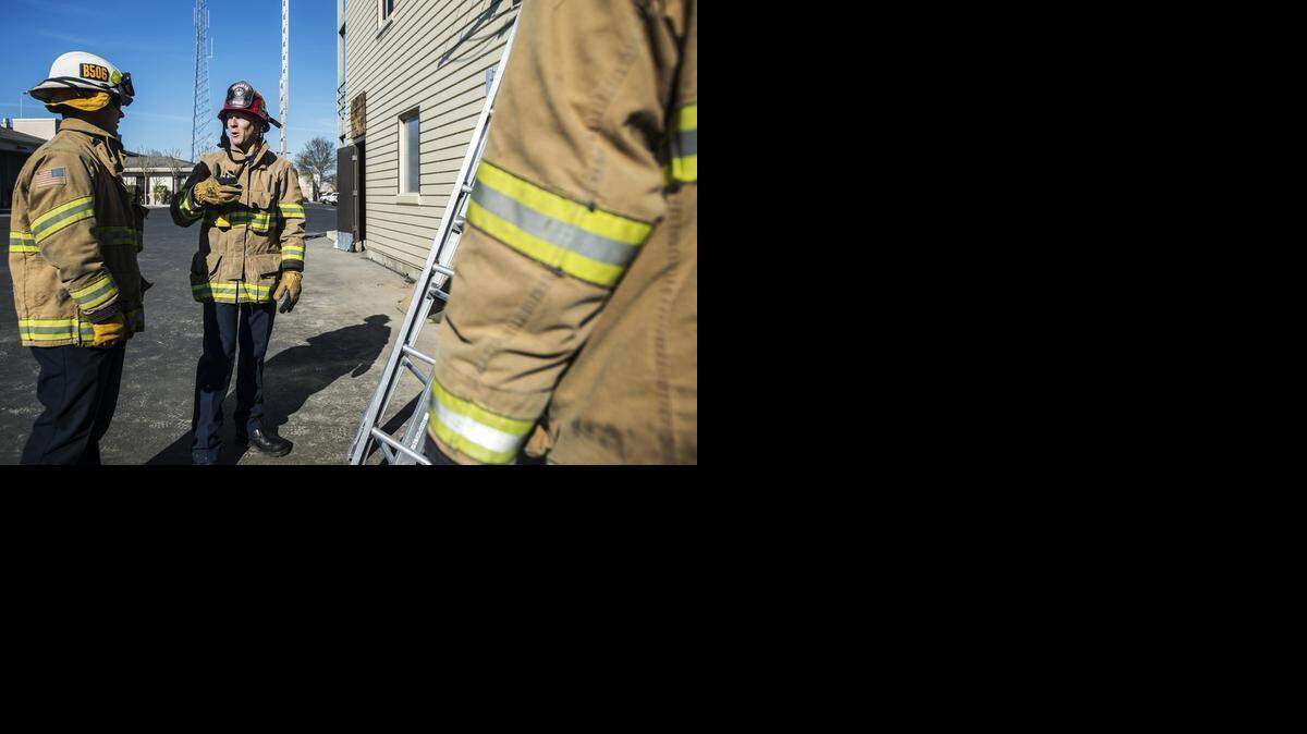 
Capt. Ryan Wells, center, speaks with Battalion Chief Billy Alcorn at the Merced Fire Department on Thursday. The department wants the City Council to end the brownout policy that has been in effect since 2012.

