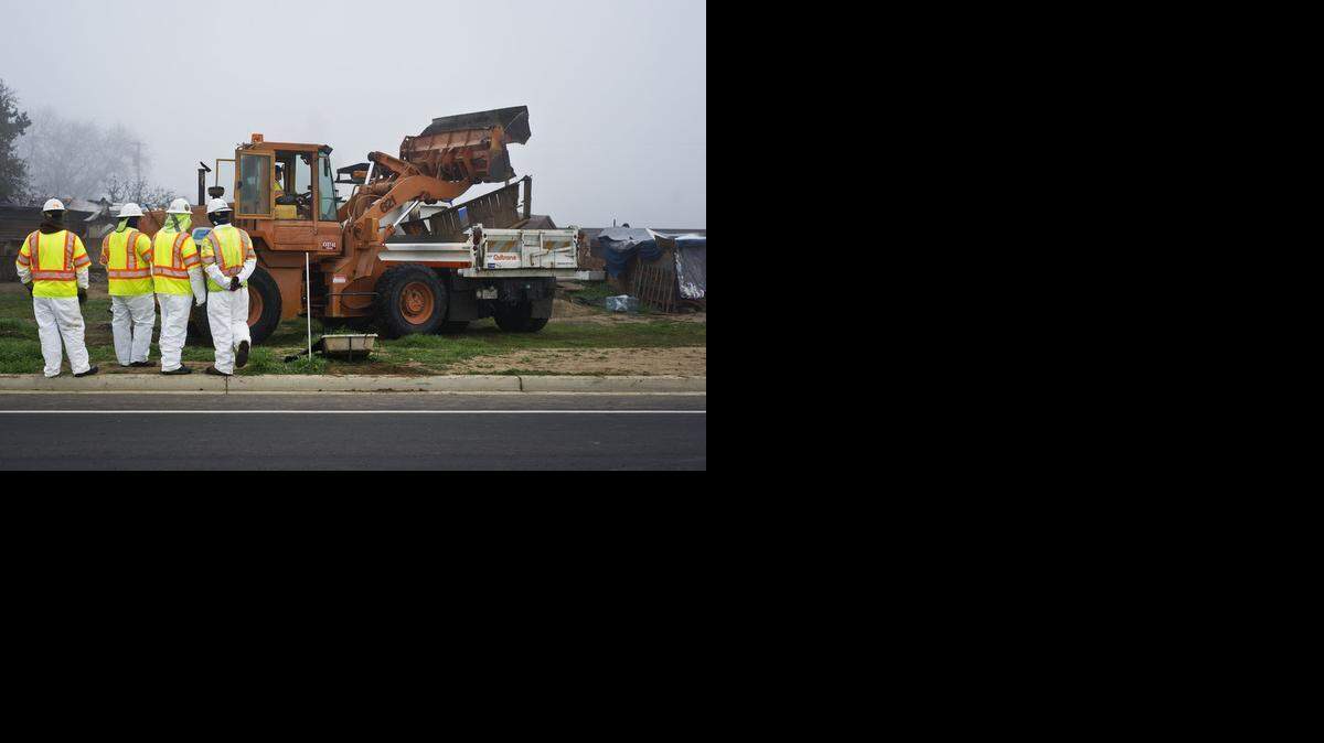 
California Department of Transportation employees and the California Highway Patrol, work to remove a homeless encampment near the Bradley Overpass and Highway 140 at Kelly Avenue, in Merced, Calif., Monday. Residents of the encampment were given notice to vacate the property owned by the California Department of Transportation, four days ago.

