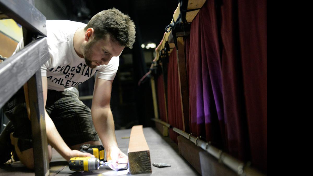 
Chris Battisti, technical director, fastens a board down inside Playhouse Merced on Wednesday. Playhouse prepares for a new season of performances.
