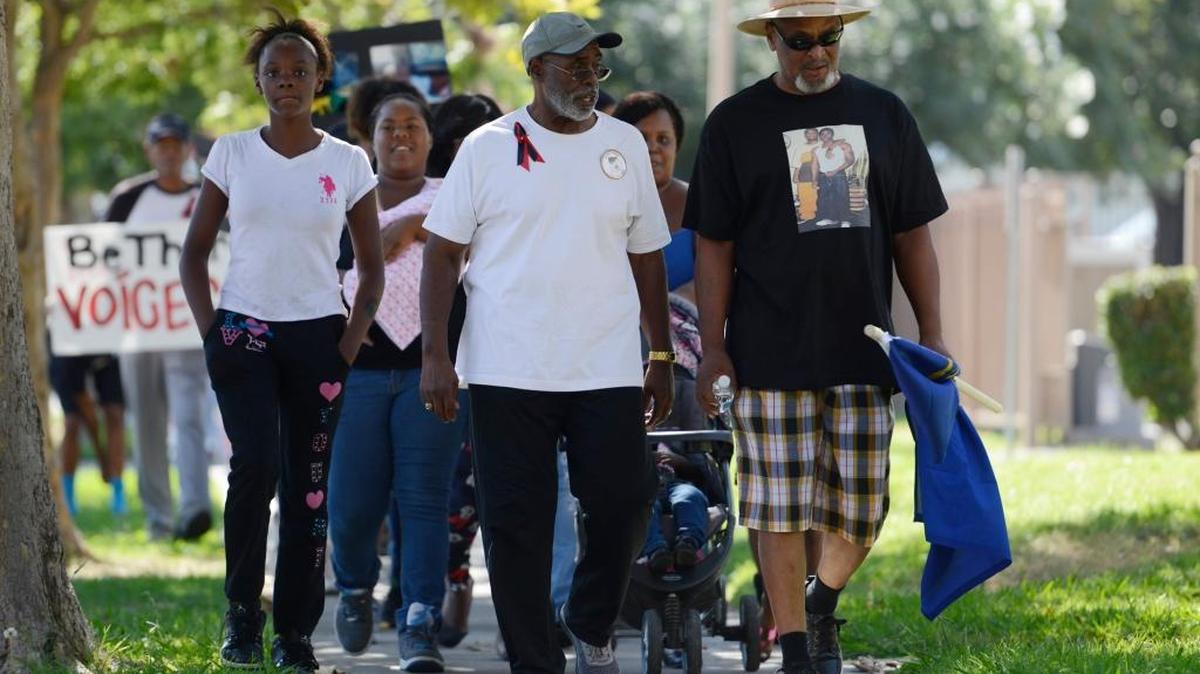 
Scores of people, some wearing ribbons and carrying signs, walk along Meadows Avenue in Merced on Saturday, Oct. 10, 2015, as part of the annual Riley Brothers Victims’ Remembrance Walk. It is named for brothers Mike and Marlis Riley, killed less than a year apart.

