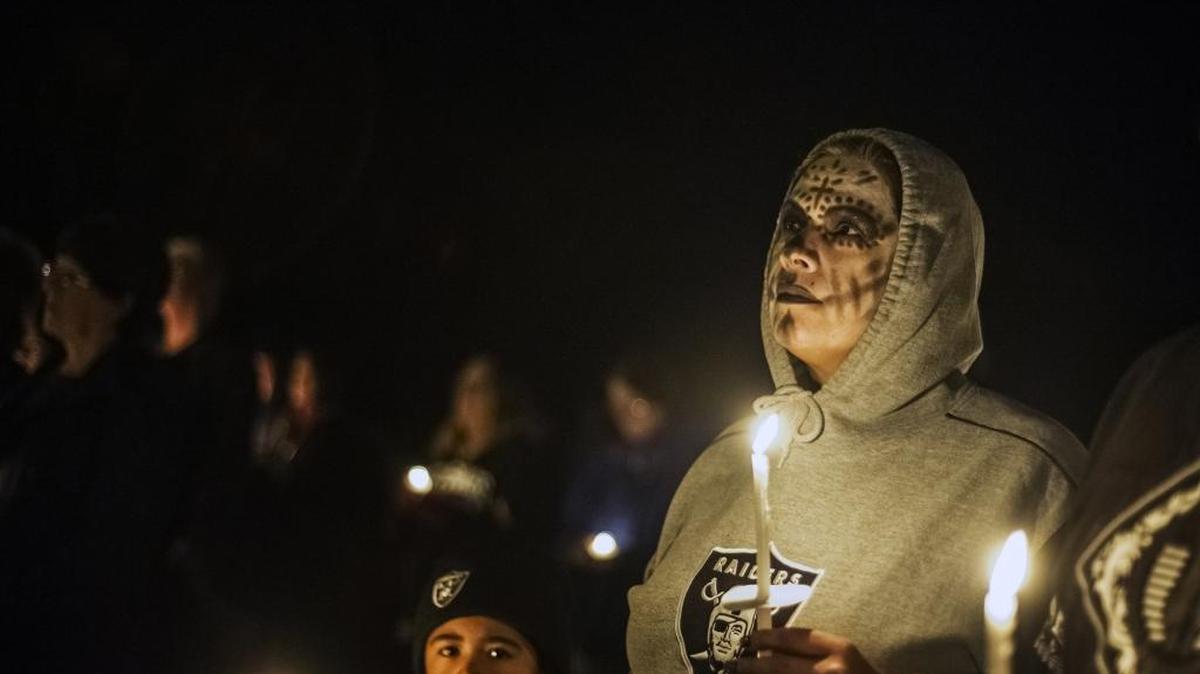 Merced resident Genia Soriano, looks to the Rev. Steve Bulfer of St. Joseph's Catholic Church during the annual observance of Dia de los Muertos, or All Souls Day in Hornitos, Calif., Monday, Nov. 2, 2015. All Souls Day is a Mexican tradition to honor and pray for those who have died before them.