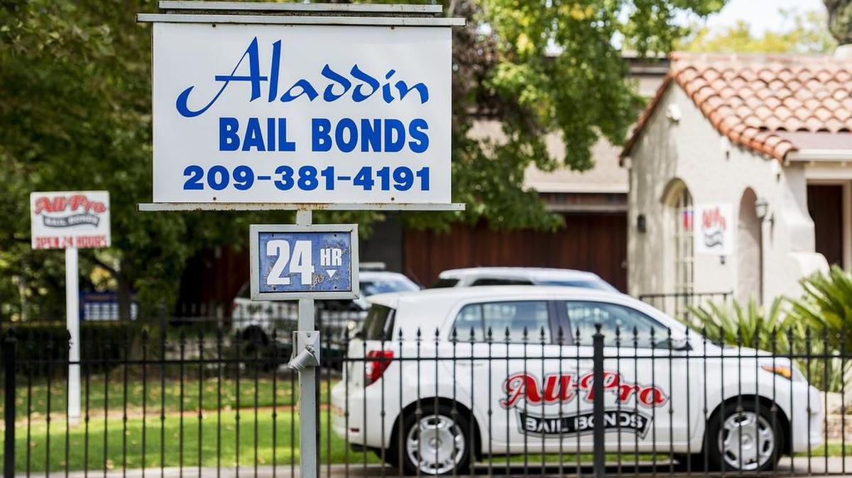 A sign for Aladdin Bail Bonds, located at 727 West 22nd Street, is seen next to the neighboring All-Pro Bail Bonds, located at 735 West 22nd Street in Merced, Calif., on Thursday, Aug. 30, 2018.