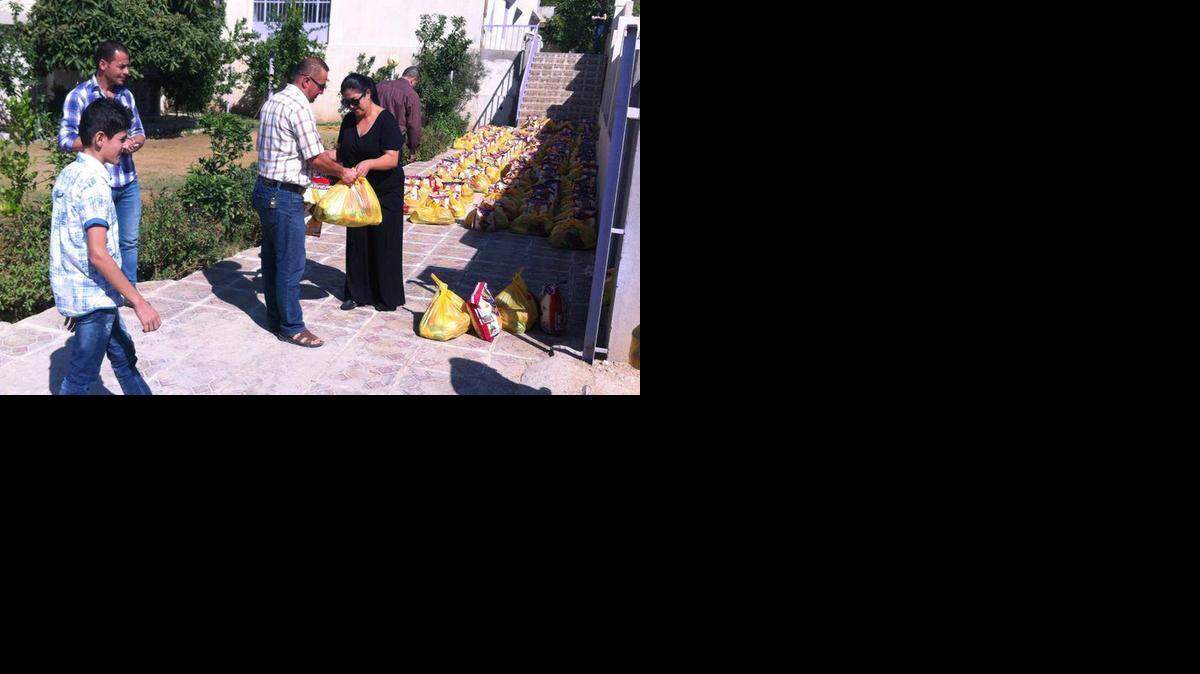 
Suzan Younan hands out supplies during her trek to northern Iraq.

