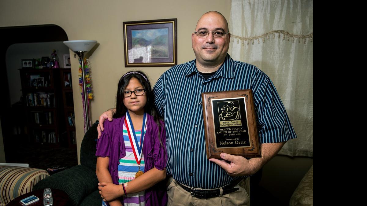 
Nelson Ortiz, 43, poses with daughter Eliana, 11, at their home in Merced on Thursday. Ortiz was named the Merced County Father of the Year.
