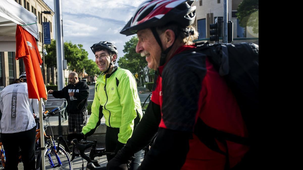 
David Gonzalves, 49, left, and Brad Grant, 64, right, both of Atwater, make a stop at the Bob Hart Square energizer station on their way to work during Bike to Work Day as part of National Bike Month in Merced, Calif., on Thursday. Gonzalves said he would bike over 20 miles round trip while commuting to and from work. Five energizer stations were available throughout the city offering cyclists various snacks, coffee and a T-shirt for participating in the event.
