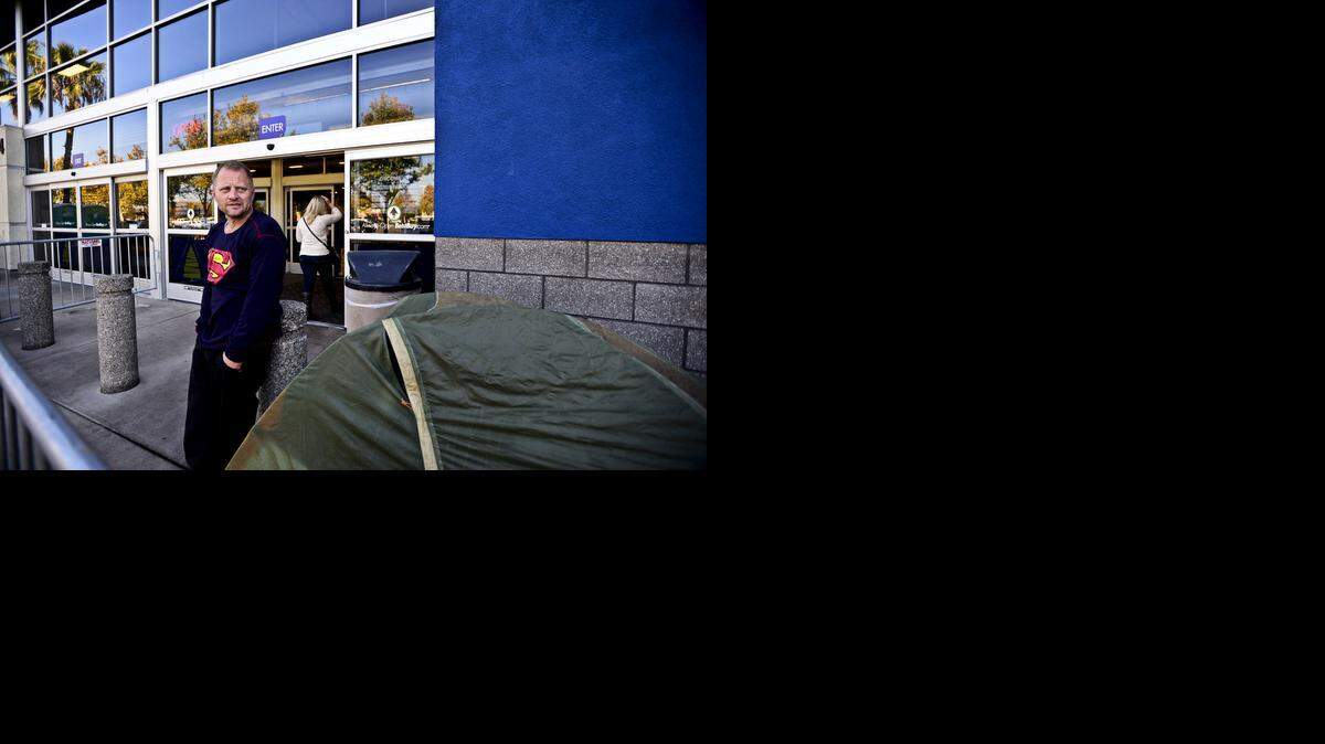 
Alfredo Ceccoli, 42, of Merced stands near his tent outside Best Buy at 1764 W. Olive Avenue in Merced on Wednesday. Ceccoli, who is currently unemployed and has never camped out for Black Friday shopping before, agreed to do so after a friend offered to pay him $100 a day as well as provide him with free meals to hold the spot in line. According to Ceccoli, he arrived at the location around 1 a.m. Wednesday morning.
