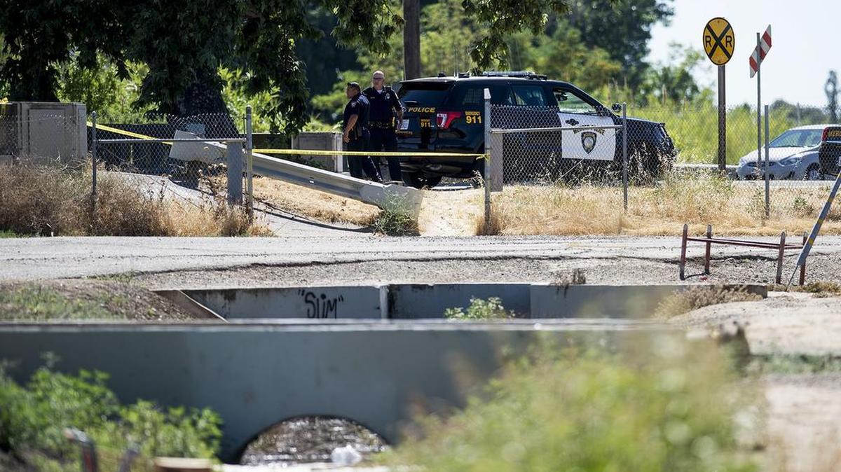 Merced Police secure the scene where a possible dead body was found in Bear Creek near the West 16th Street overpass in Merced, Calif., on Saturday, June 16, 2018. According to Sgt. Joseph Weiss, a passerby was walking along the West 16th Street overpass when an unusual smell led them to the discovery of what appeared to be a body floating in the creek.