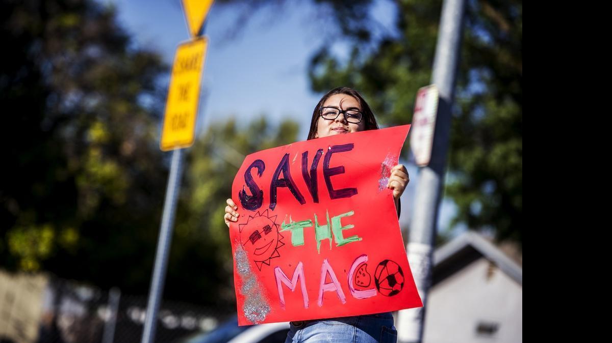 
Youth I Can president, Jessenya De La Rosa, 17, of Merced, holds a sign to passing motorists during a news conference announcing plans to push for youth funding at McNamara Park in Merced, Calif., Tuesday. They are calling the effort "#BackTheMac." in reference to McNamara Park.
