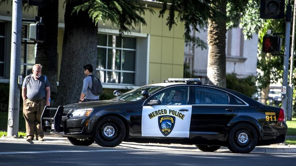 A Merced Police cruiser turns onto West 21st Street in downtown Merced, Calif., in May.
