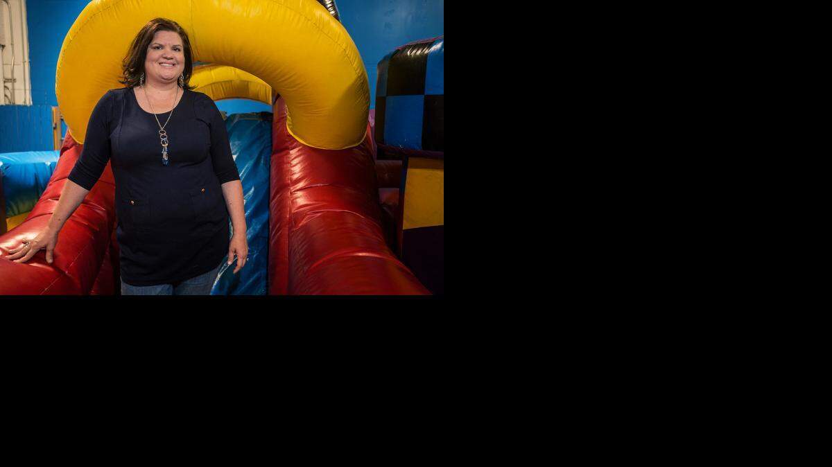
Kellie Kennedy, owner and operator of Inflatable Fun, poses Friday for a portrait on an obstacle course at the business, 1735 Ashby Road, Suite C, in Merced.There’s also an inflatable bounce house and giant slide. 
