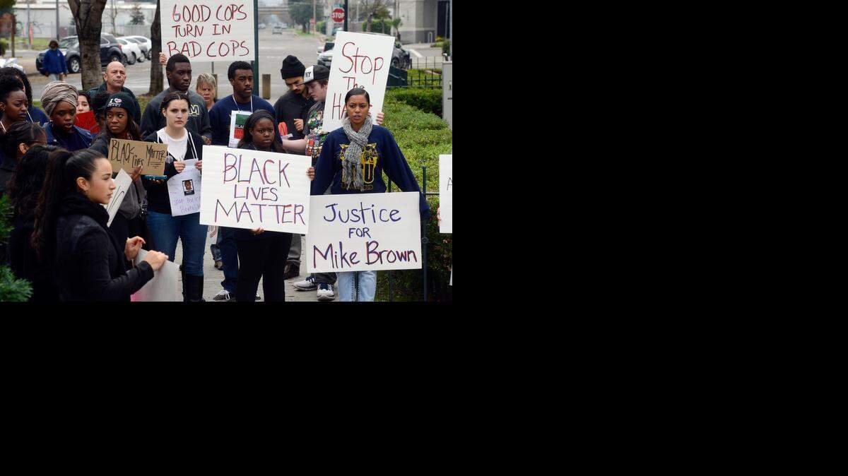 
About 50 demonstrators gather in Bob Hart Square in Merced while chanting about police brutality and holding signs on Saturday. The protest was held in conjunction with similar events in Berkeley and New York.
