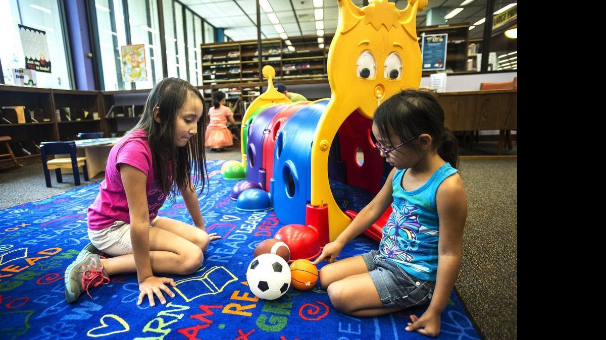 
Layla Castrillo, 10, left, and Raquel Barriga, 4, right, play inside the Merced County Library in Merced, Calif., Wednesday. The ranking and review website Niche.com, included communities in Merced and Stanislaus counties in its top 100 list of “best towns to raise a family in California..

