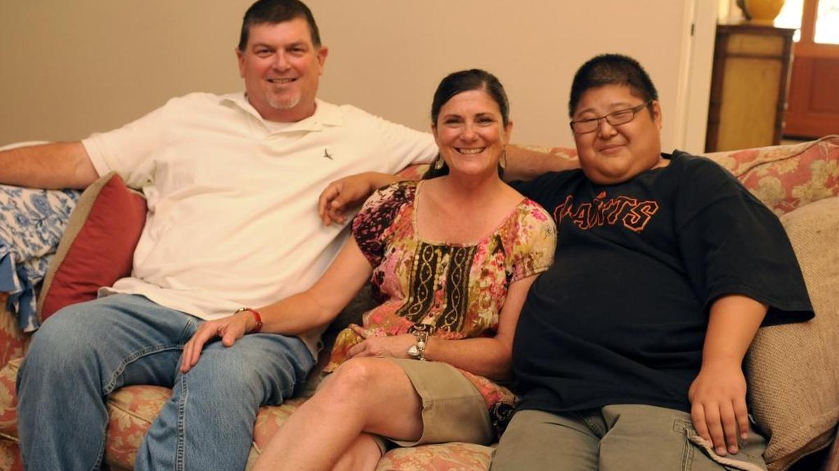 Jon Dibblee, left, shown here in 2012 with his wife Cindie and son Alex at home. Jon Dibblee, who was a longtime history teacher and girls water polo coach at Merced High, died on Wednesday morning after a long battle with cancer.