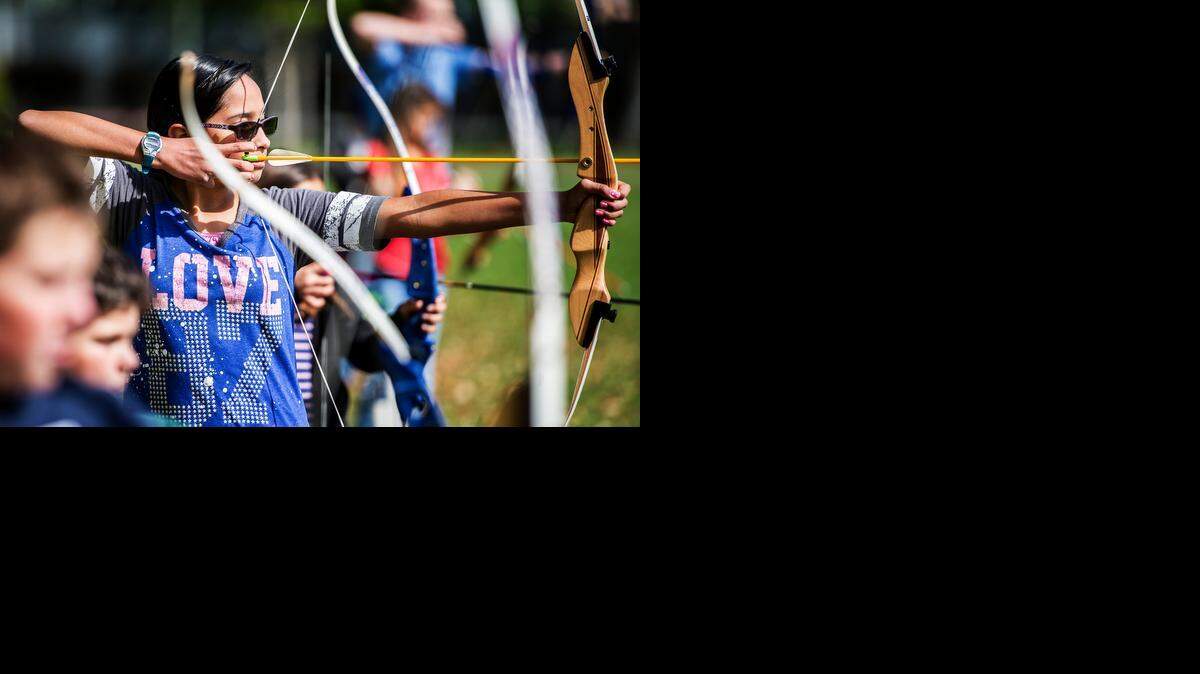 
Anaya Cambridge, 12, of Merced, draws back her bow as she takes aim during the Merced College Community Services Easter Archery Class on the lawn of Merced College on Thursday. The 19 student class, consisting of beginners and experienced archers, shot at homemade Easter targets.
