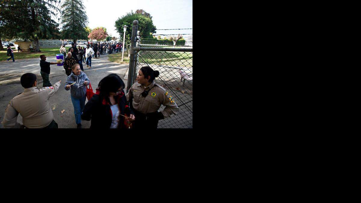 
Residents wait in line during a turkey giveaway at the Merced County Fairgrounds last month. Greg Hostetler, owner of Hostetler Ranches, and volunteers distributed 500 turkeys and 500 bags of almonds to Merced residents. Hostetler has been organizing the turkey giveaways for more than 30 years.

