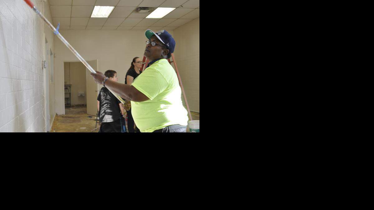 
Rachelle Abril, founder and director of Mentoring Odd Jobs Organization, paints the walls at the McNamara Youth Center on Monday.
