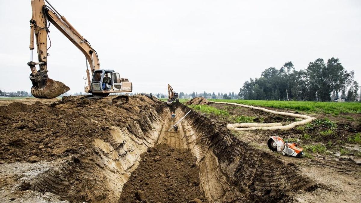Construction crews work on a section of land along Compass Pointe Avenue in Merced on Friday, Jan. 29, 2016.