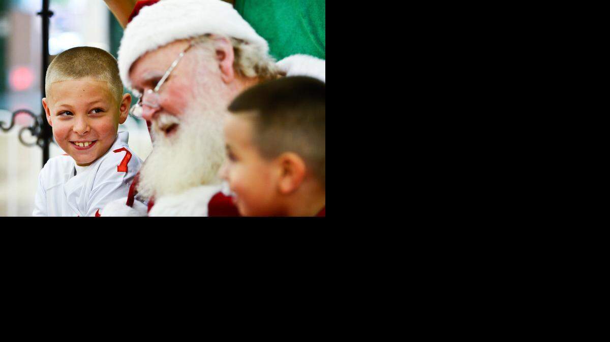 
Atwater resident Dustin Henderson, 9, smiles at Santa Claus with Eligh Anaya, 4, right, at the Merced Mall in Mercedon Thursday.
