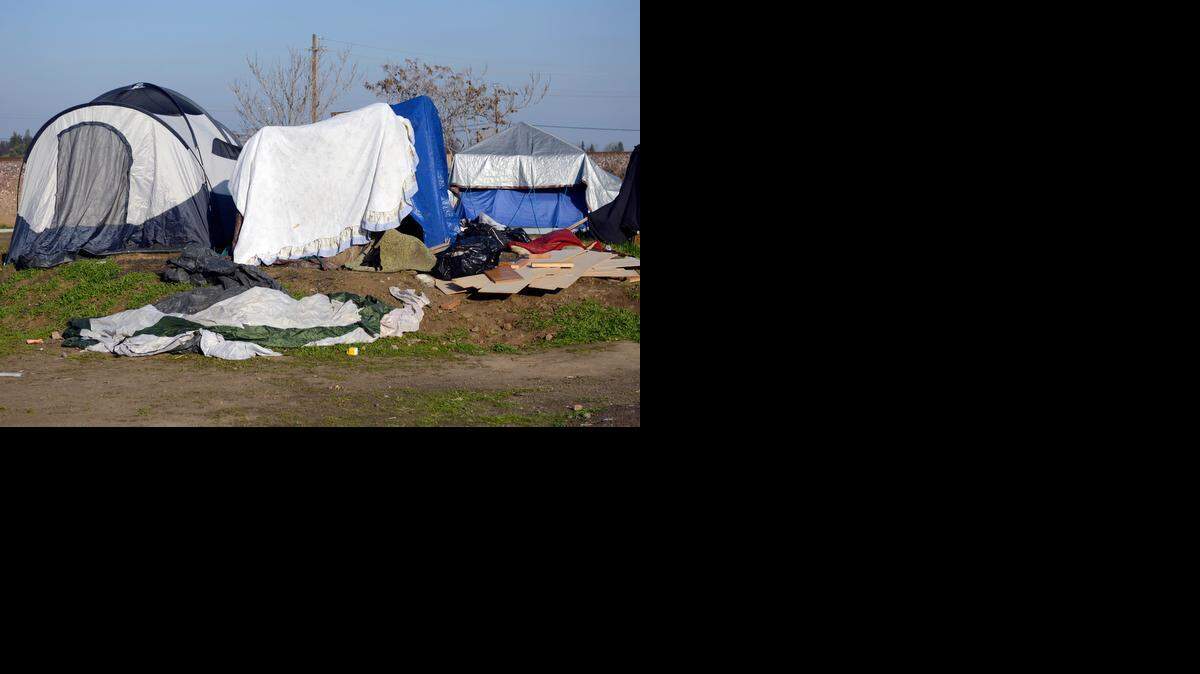 
An encampment of homeless people who live in several tents and makeshift shelters sits just north of the Bradley Overhead on State Route 140 on Monday. The California Department of Transportation has confirmed plans to clear out the camp out with the help of California Highway Patrol and homeless advocates.
