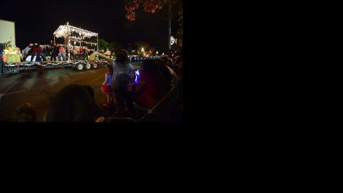 
Onlookers wave to a float Friday during the Atwater Christmas Parade on Broadway Avenue in Atwater.
