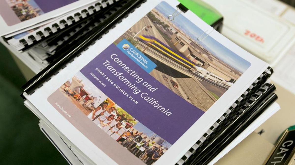 Copies of the new proposed business plan for the California High-Speed Authority are seen at a information hearing on the bullet train, at the Capitol in Sacramento on March 28. Lawmakers questioned rail authority officials about the new plan that calls for overhauling the proposed route and postponing the first service by three years, pushing Merced’s stop back seven years.