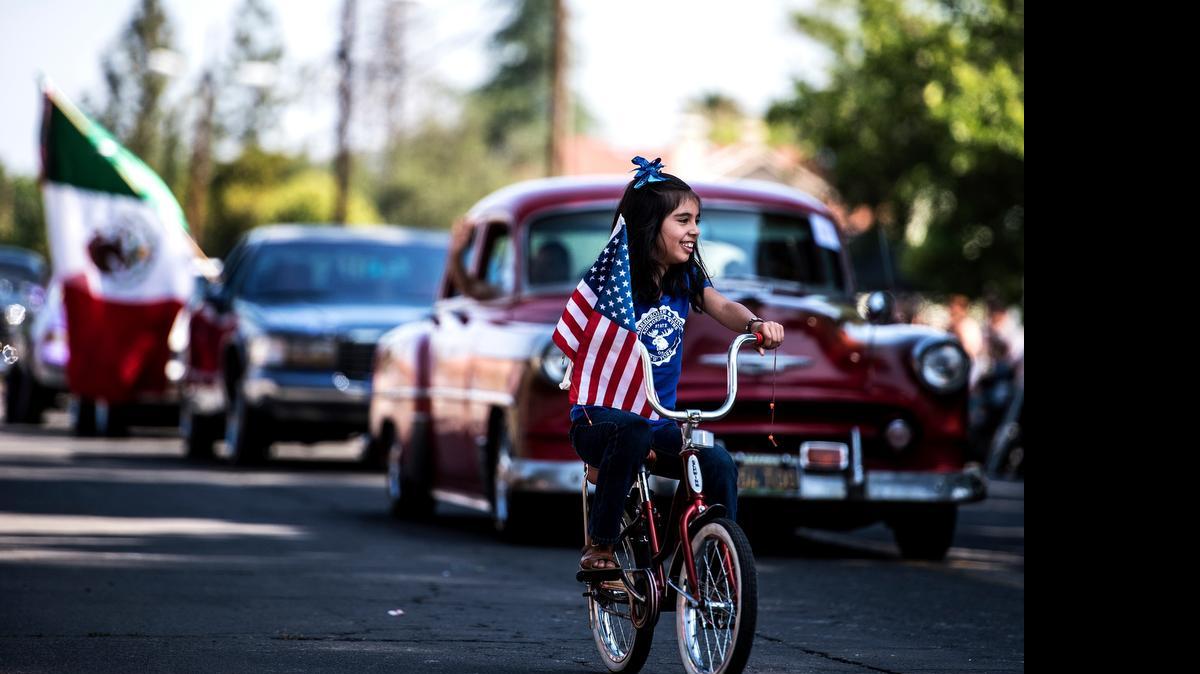 
Marahi Gutierrez, 8, of Merced rides her bike during Planada’s annual Community Day parade Saturday.
