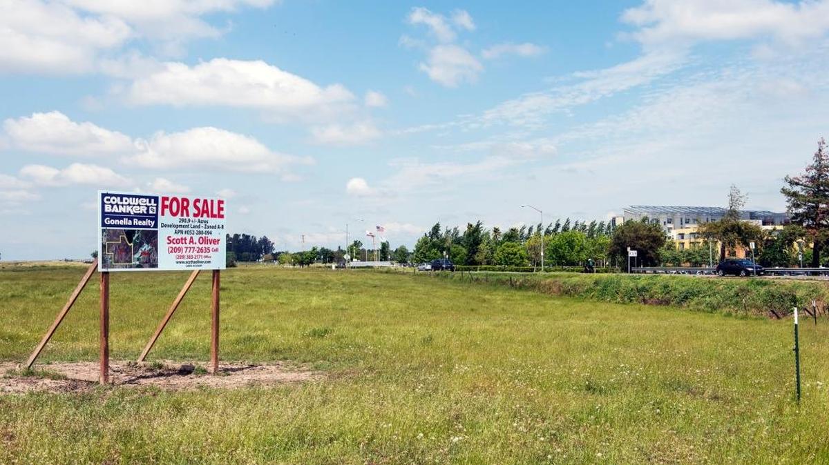 This empty land across from the University of California, Merced at the intersection of East Bellevue Road and Lake Road in Merced, Calif., is the site of the planned development of $240 million in new apartment projects. A tentative tax-sharing plan on the project that was agreed to by the city and county of Merced has been finalized and will be taken up by the Merced City Council on Monday.