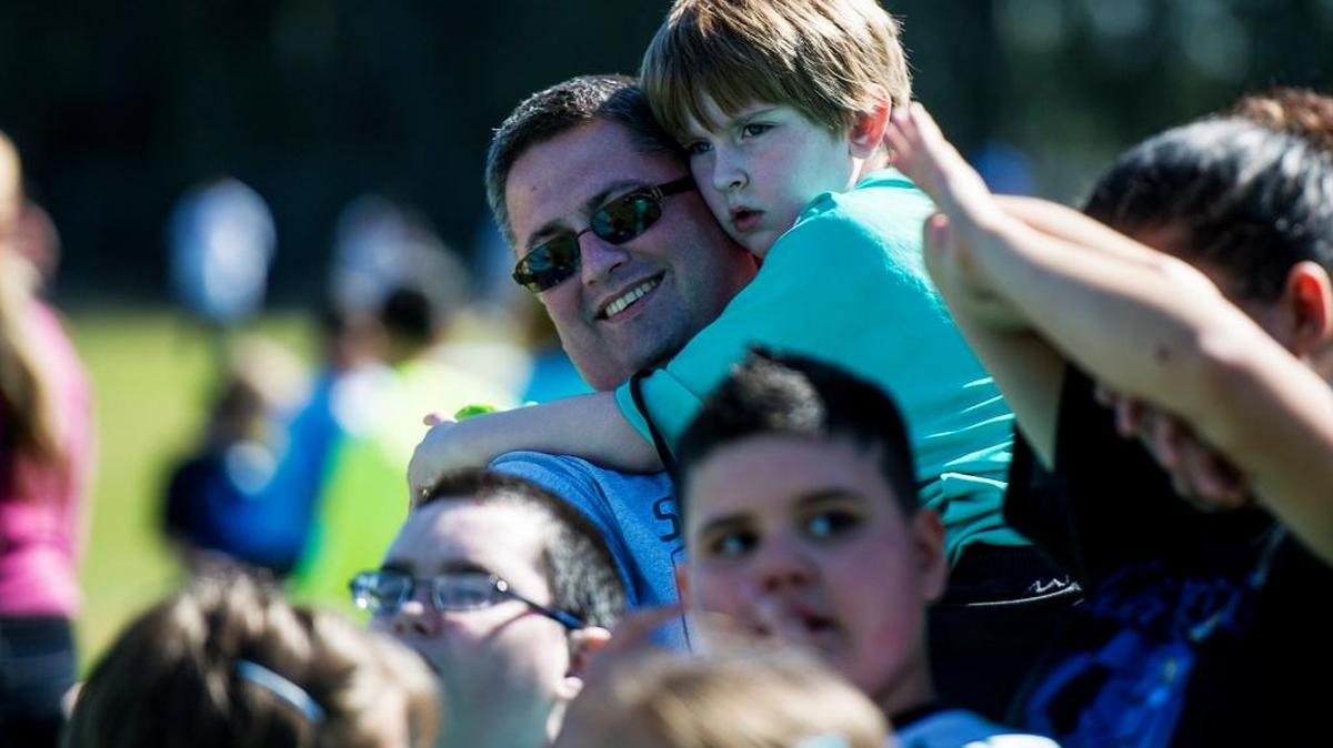Dylan Mankin, 6, of Chowchilla hugs his father, Loren Mankin, during a soccer event at McSwain Elementary School in Merced, Calif., on Saturday, April 2, 2016. Central San Joaquin Valley cities that lost population, including Chowchilla, were most significantly affected by their state prisons, whose inmates are considered residents in the communities where they are imprisoned. Chowchilla, which has men’s and women’s prisons, lost a total of 415 inmates. Its population fell to 18,547, or 1.3 percent.