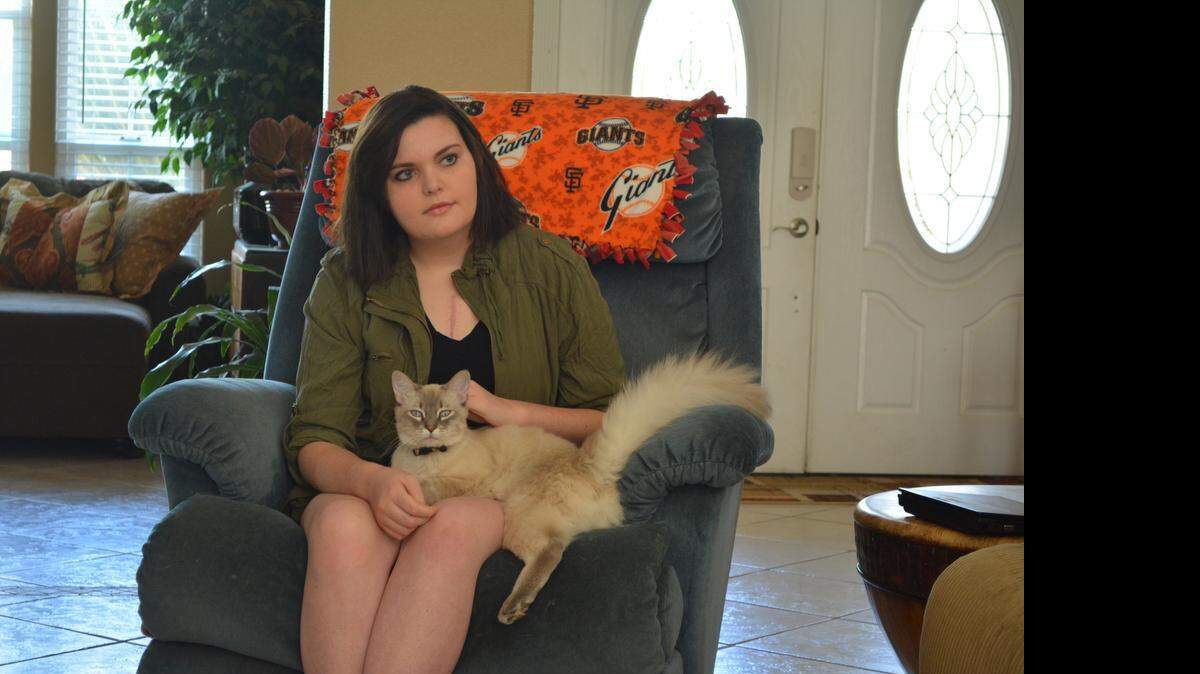 
Shea McNeely, with her cat, Rex, listens to her mother, Rhonda, discuss Shea’s heart-lung transplant on Monday (04-20-15).

