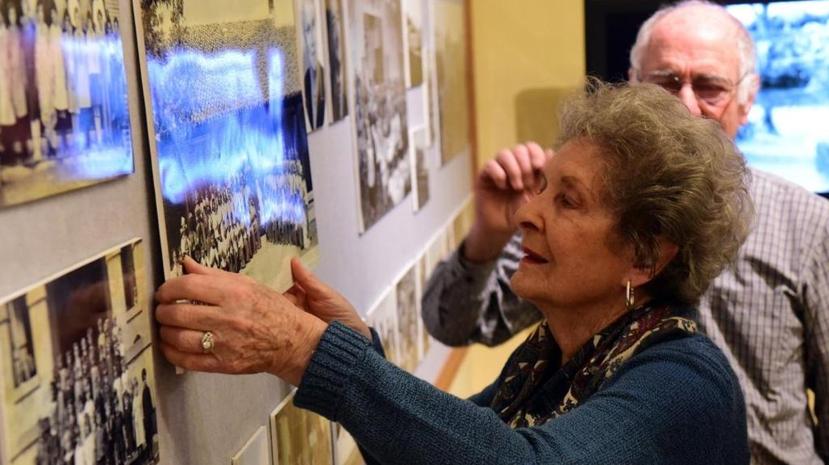 Lillian Dal Porto, 92, of Merced hangs a photo from a picnic at the Merced County Courthouse Museum on Monday, March 13, 2017. The Grazie America! From Italy to Merced County, an exhibit about Italian immigrants, opens Thursday.