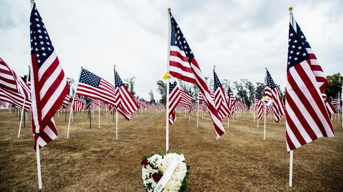 A wreathe is placed at the base of flag at the third annual Field of Honor display located on the font lawn of Merced College in Merced, Calif., Monday, Nov. 9, 2015.