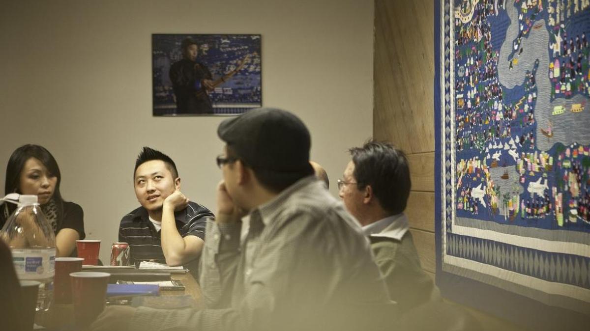 Members of the Hmong American Writers’ Circle discuss literature in Fresno, Calif., Dec. 9, 2011. As the first generation to grow up with a written language rather than the traditional spoken word, members of the circle are addressing a new kind of coming of age in America. From left: Mary Yang, Burlee Yang, Pos Moua and Andre Yang.