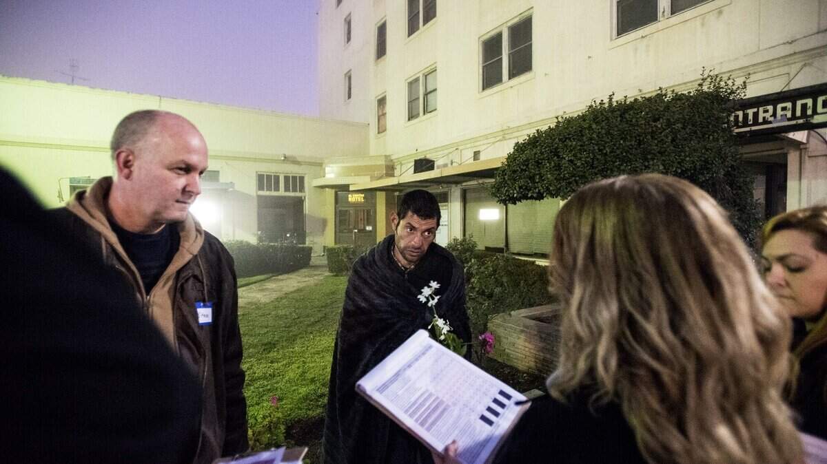 Nitro Ricardo Rodriguez, 38, center, a homeless man, speaks with volunteers during the 2016 Merced City and County Continuum of Care Homeless Count in Merced, Calif., Thursday, Jan. 28, 2016. Approximately 150 volunteers walked the city to speak with the homeless and offer them a quarter gallon bag containing snacks, socks and various hygiene products.
