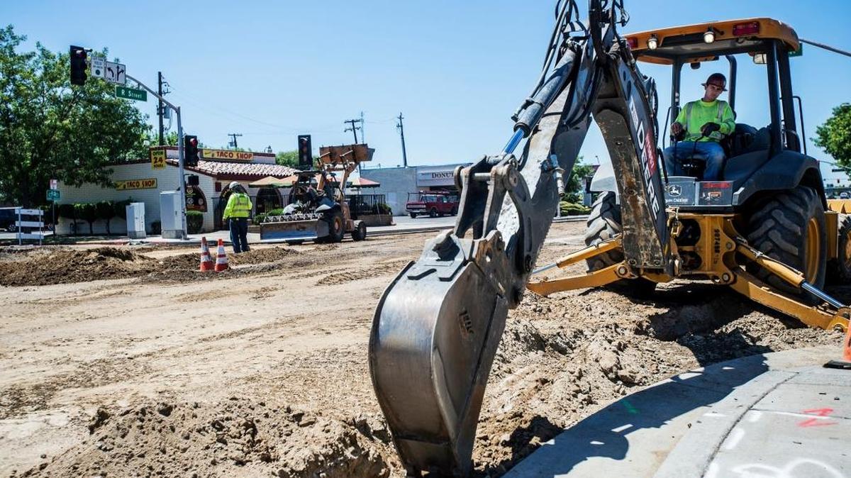 St. Francis Electric employee Justin Dionisio digs a trench amid road work along R Street in June. A half-cent sales tax to pay for road projects had strong support from voters as of Wednesday, though many ballots had not yet been counted.
