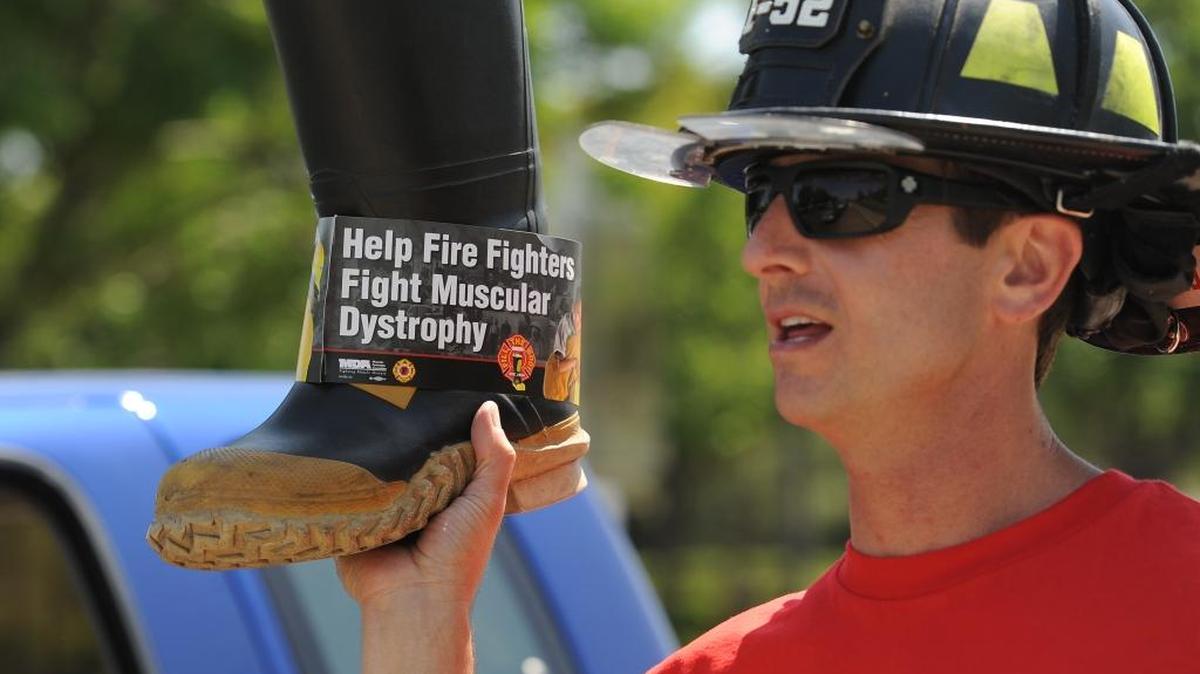 Merced Fire Department firefighter and event organizer Jeff Trost raises money during the union’s annual “fill the boot” fundraiser in Merced in 2013.