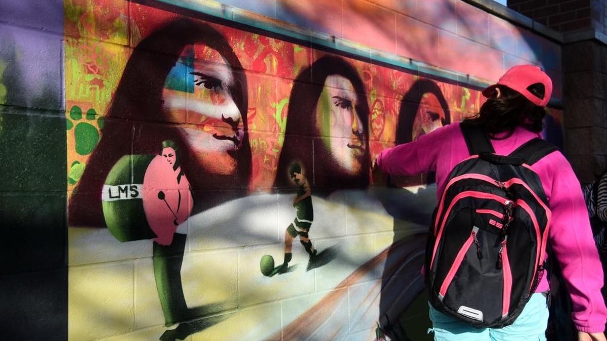 Esmeralda Ortiz, 12, checks out the newly finished mural at Livingston Middle School, which she contributed to, on Friday, Jan. 15, 2016.