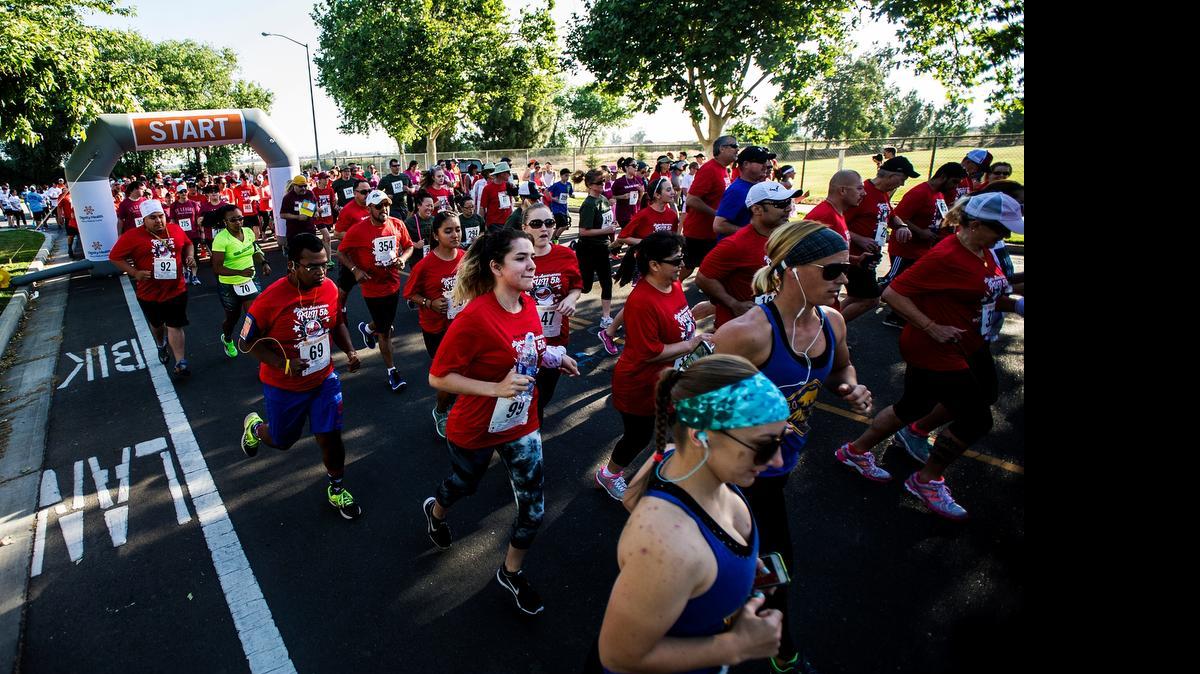 
Runners and walkers take off from the start line during the Mercy Medical Center Merced's Stroke Awareness 5K in Merced, Calif., Saturday, May 2, 2015. According to hospital spokesman, Bob McLaughlin, more than 400 participants signed up for today's event.
