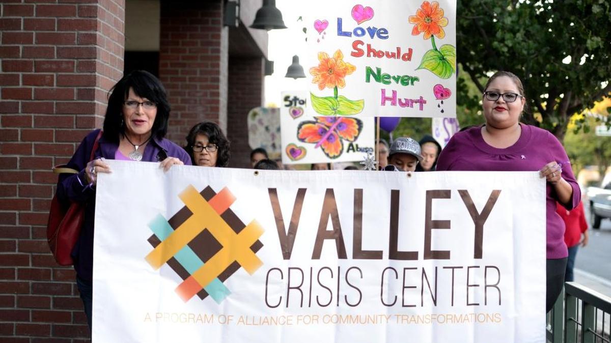 Victoria Camarillo and Brenda Troncoso-Zamora of the Valley Crisis Center lead the march against domestic abuse along M Street on Thursday, Oct. 29, 2015.